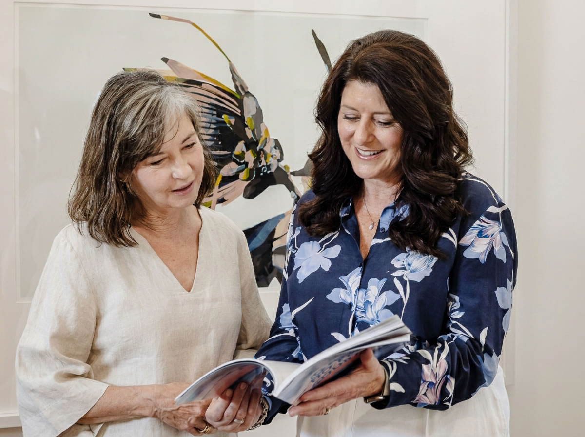 Tanya Perry-Iranzadi and a colleague reviewing leadership development materials