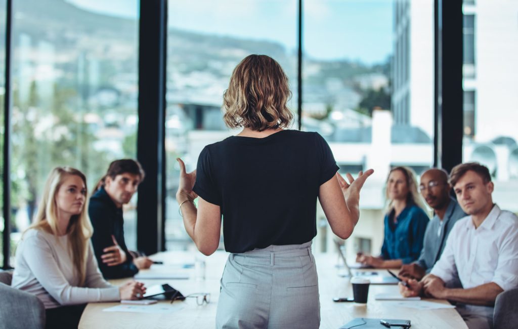 Woman presenting to colleagues during a leadership meeting