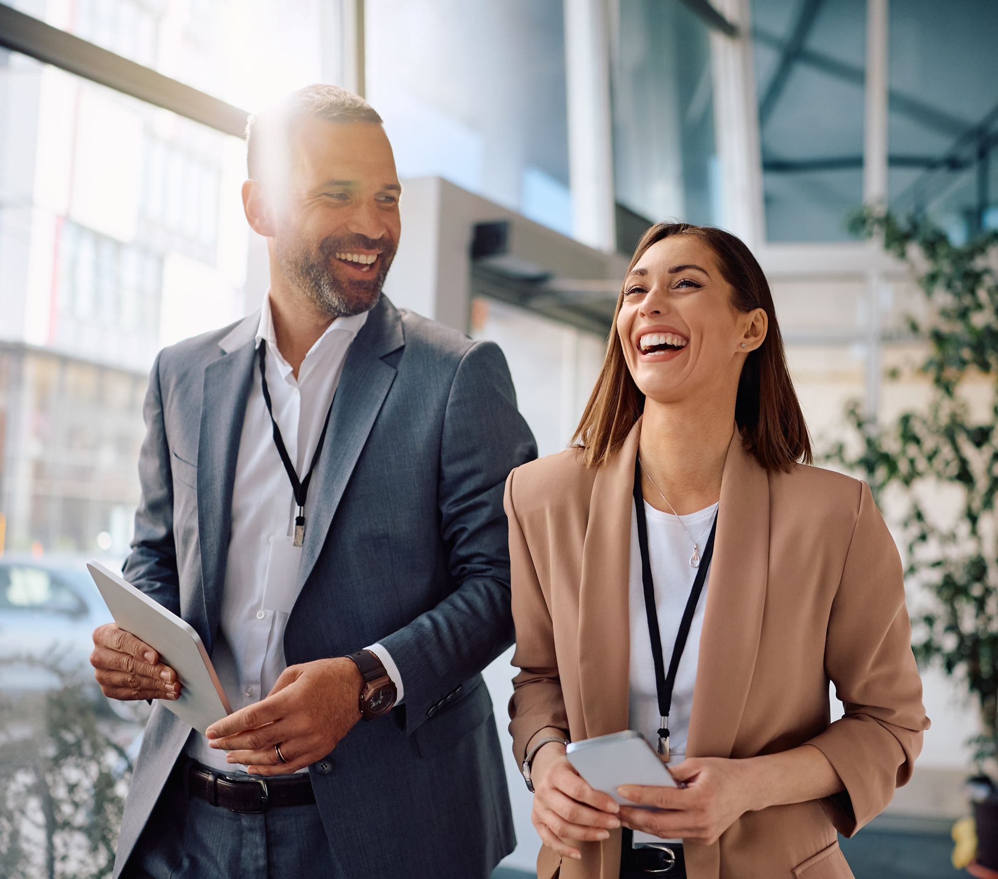 Female and male leaders talking together in a modern workplace