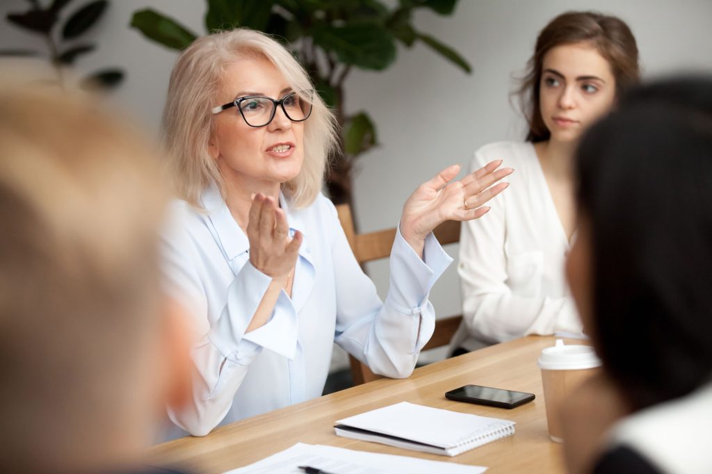 Senior woman leader speaking during a team discussion